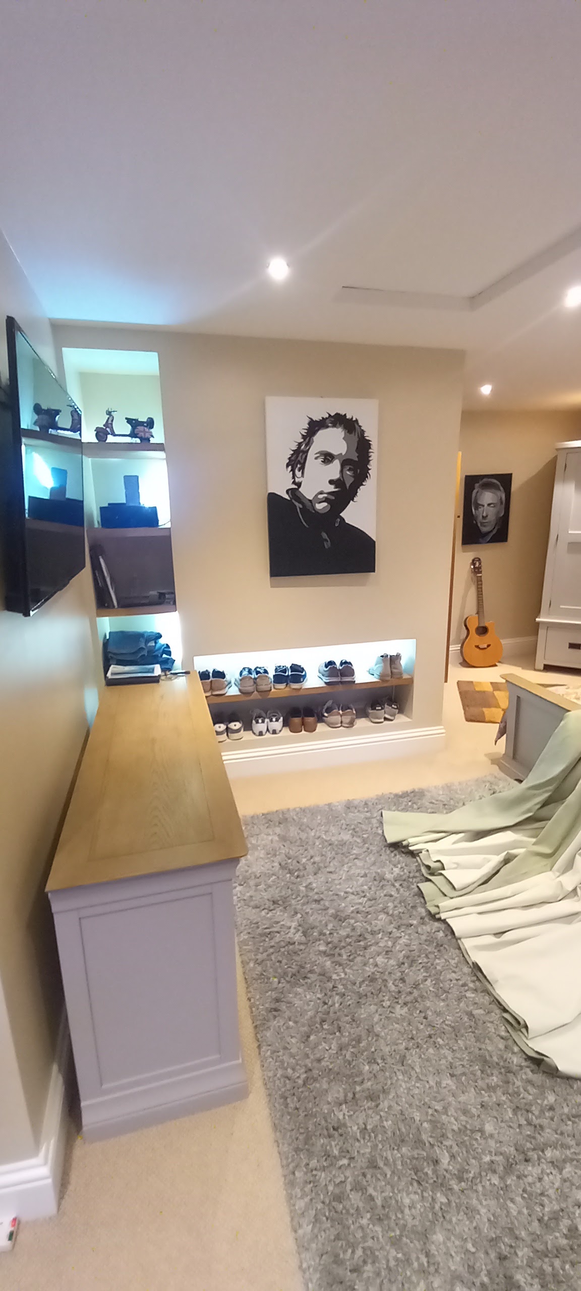 A decorated media room with a feature wall and lighting