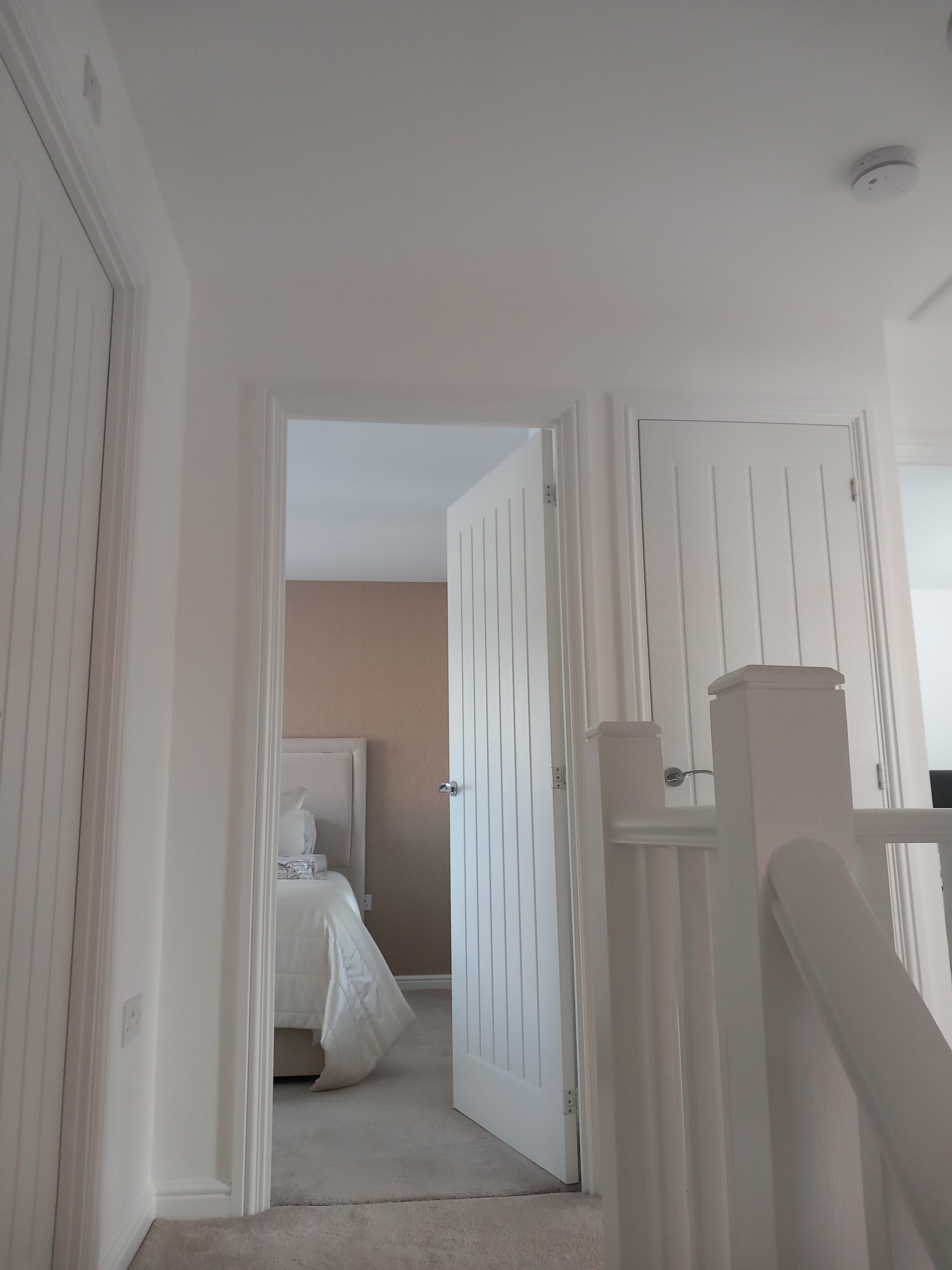 A landing with painted doors and woodwork