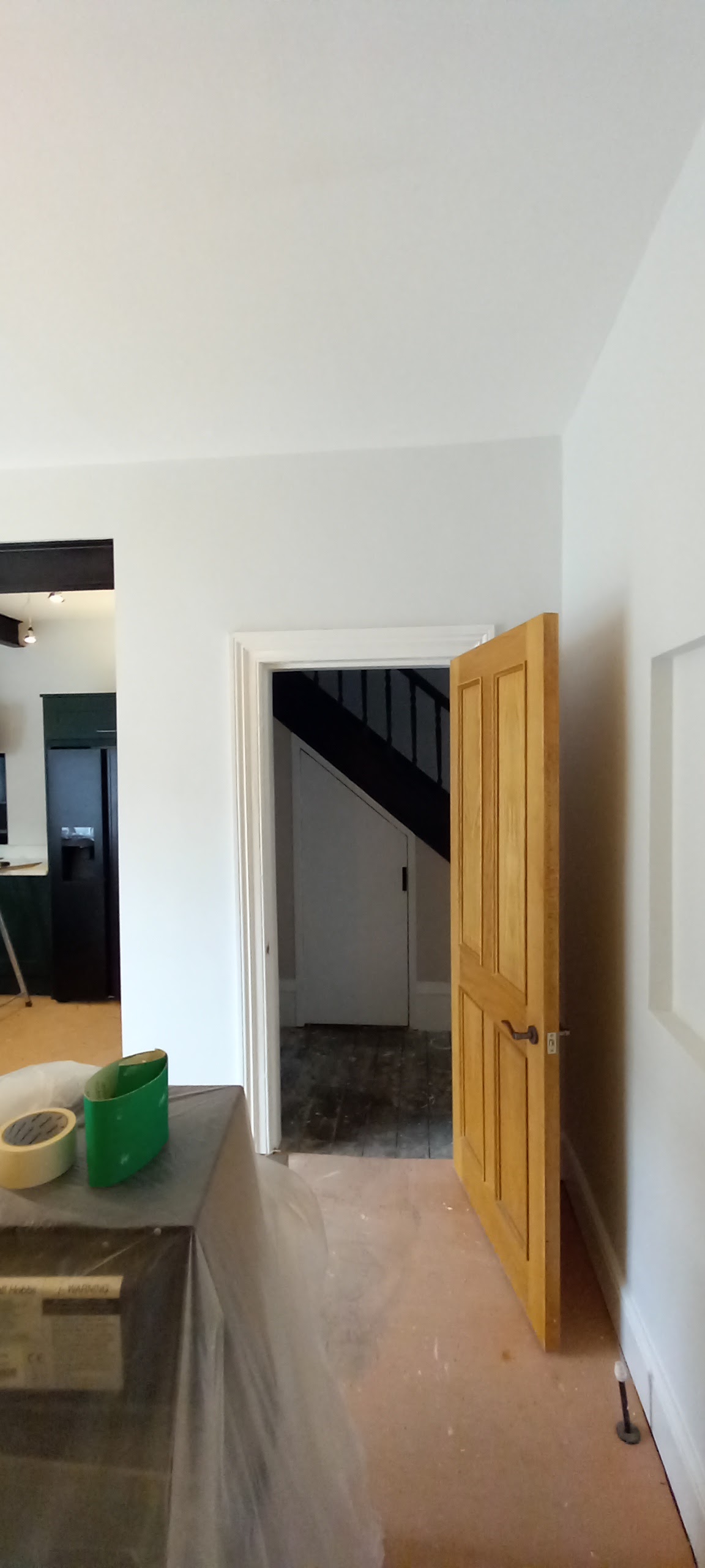 An oak door and a painted hallway